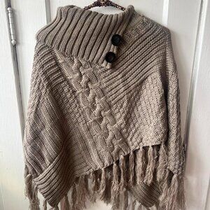 Tan and brown crochet poncho shrug with tassels.